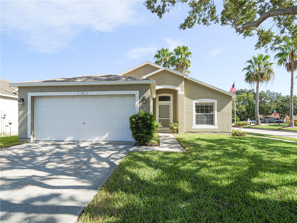Single-story residence featuring a stucco exterior, an attached two-car garage, and a concrete driveway