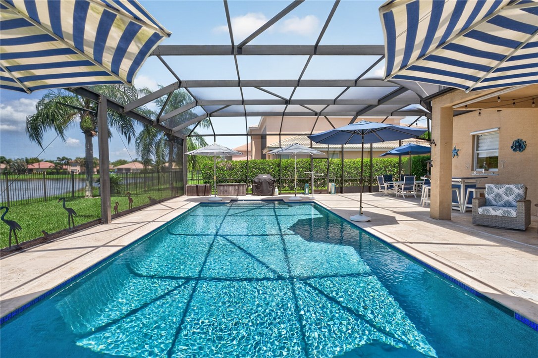 Screened-in swimming pool with a surrounding paved deck