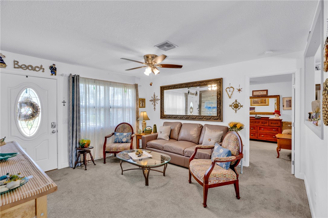 Living room leads to primary suite