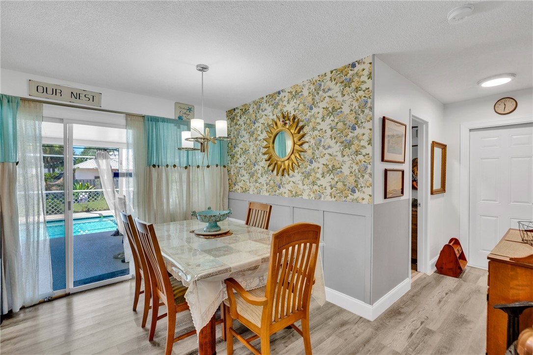 Dining area with accent wall overlooking patio and​​‌​​​​‌​​‌‌​​‌‌​​‌‌​​‌​​​‌‌​‌​​​‌​​​​‌​ pool