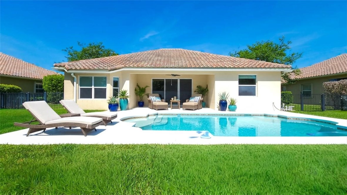 Exterior with a barrel tile roof, stucco finish, and a concrete patio