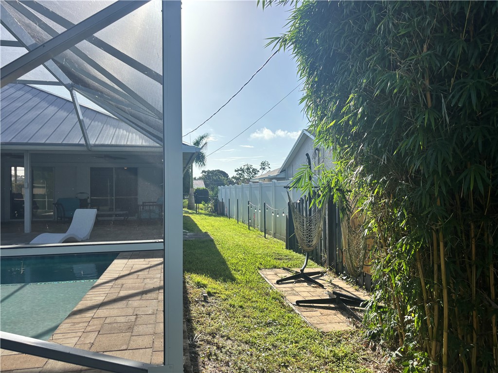 Screened-in pool enclosure with brick paver decking