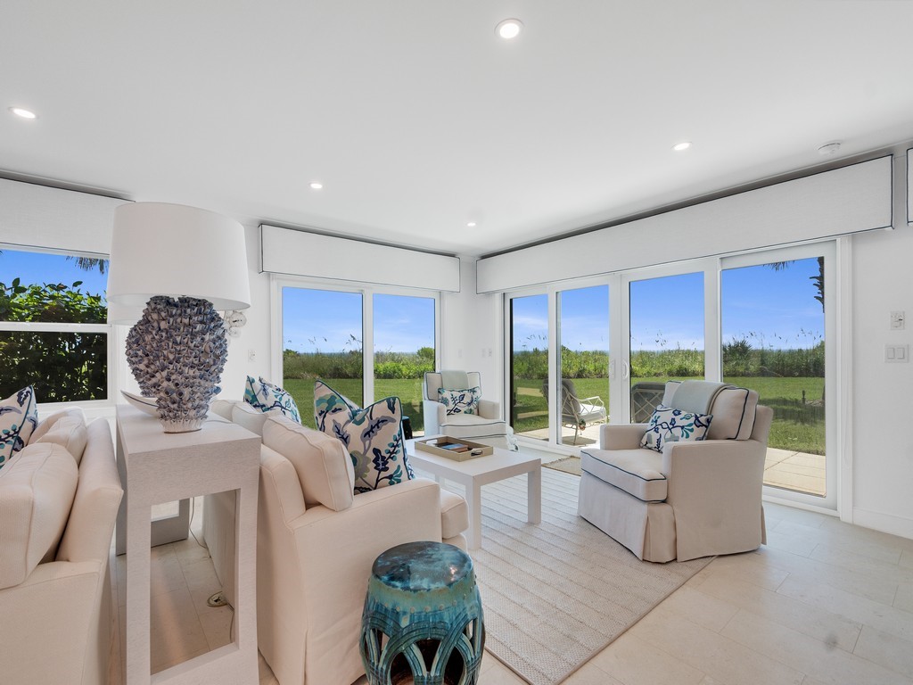 Sliding glass doors, recessed lighting, and light wood-finish flooring