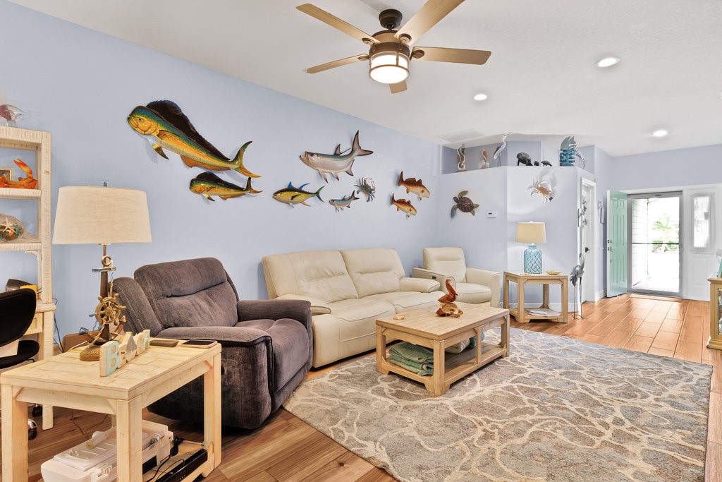 Recessed lighting, wood-finish flooring, ceiling fan, and built-in shelving
