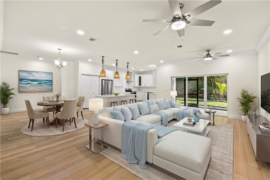 Open-concept living area with wood-finish flooring, recessed lighting, and ceiling fans
*Virtually Staged
