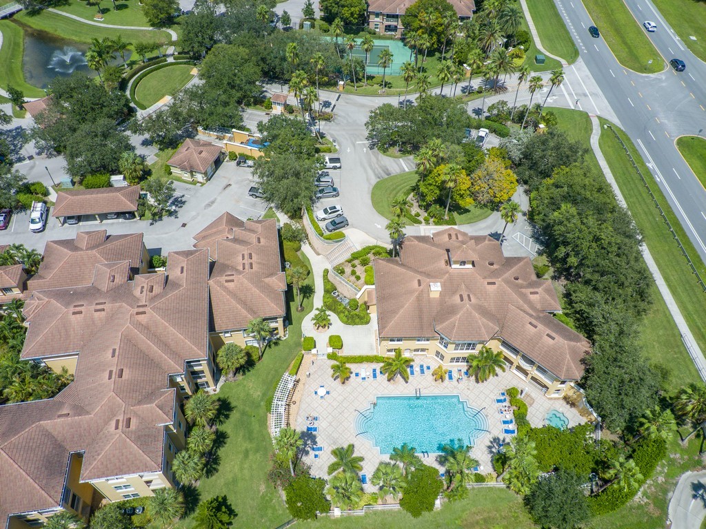 Expansive community amenities including a large swimming pool, spa, and tennis courts