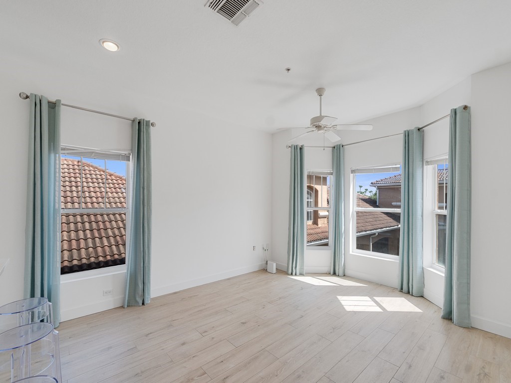 Bright living room featuring ceramic flooring, recessed lighting, and a ceiling fan