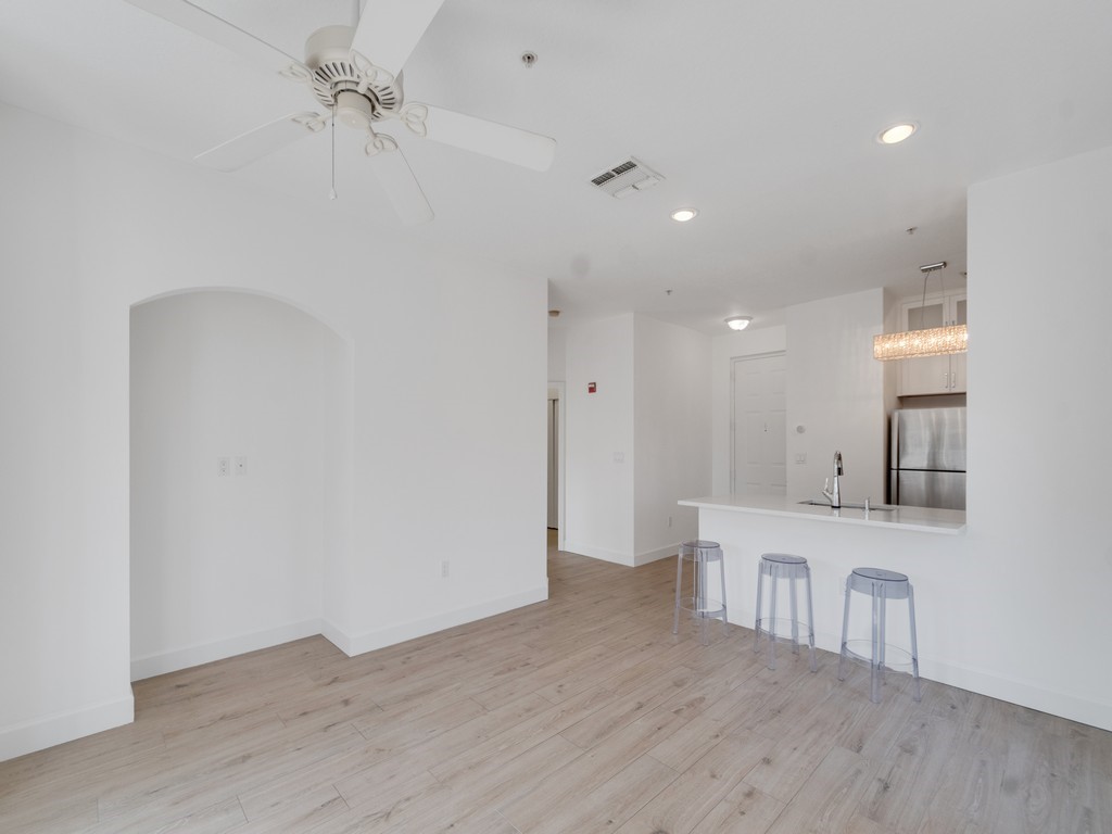 View from far wall of living room toward kitchen and bedroom