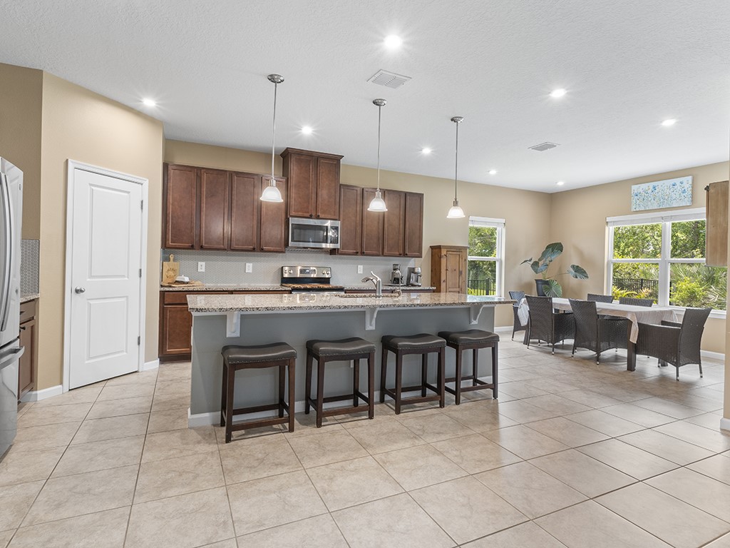 Open-concept kitchen and dining area featuring tile flooring