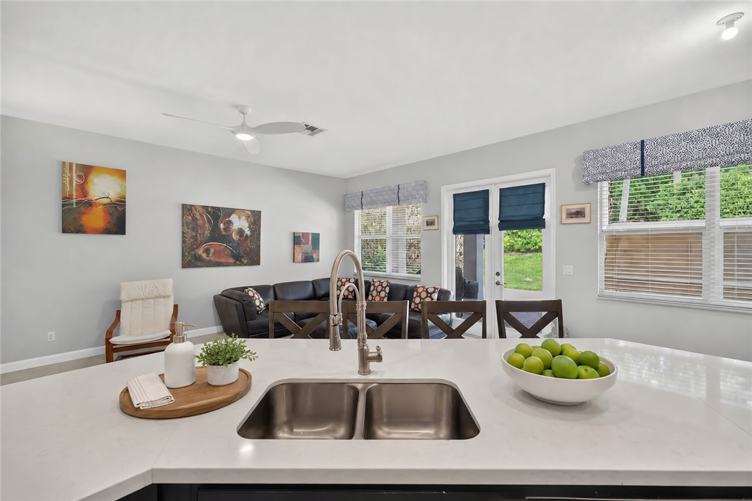 Kitchen island with a double basin stainless steel sink and gooseneck faucet