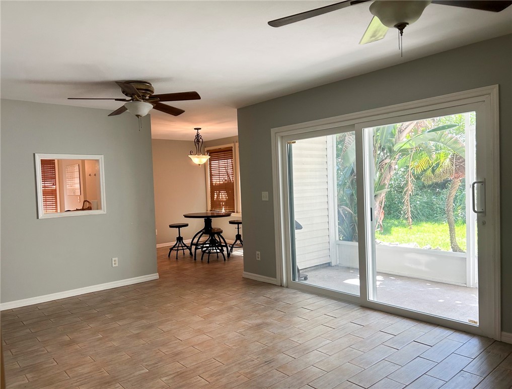 Living room with sliders to screened porch; passthru window to kitchen