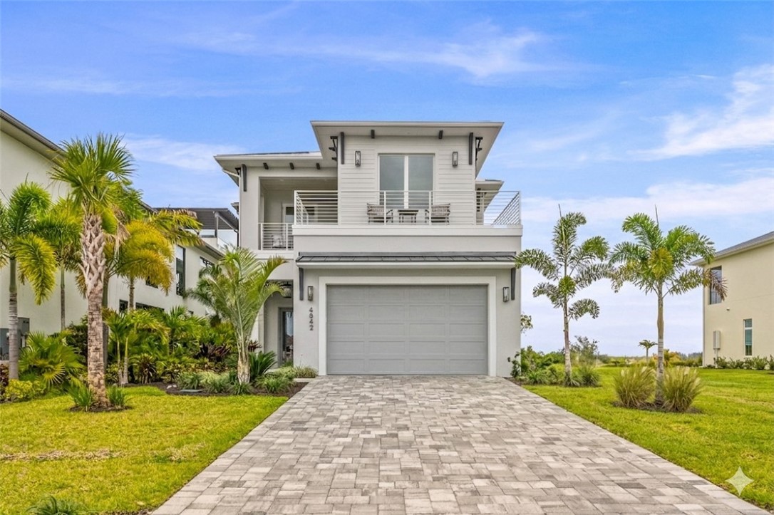 4842 S Harbor Dr Laguna Village Grand Harbor two-story home with spectacular river views features a paver driveway, an integrated two-car garage, and upper-level balconies