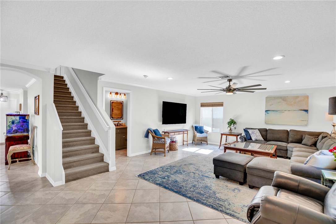 Spacious living area leading to full bathroom and upstairs