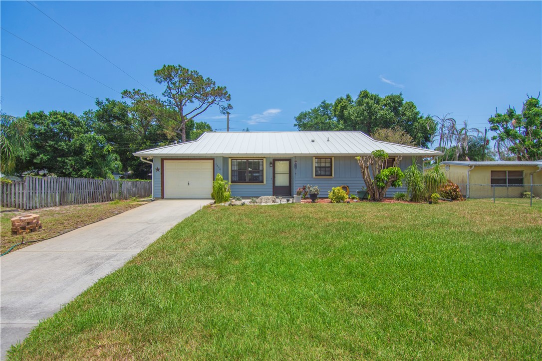 Light blue exterior with a white metal roof