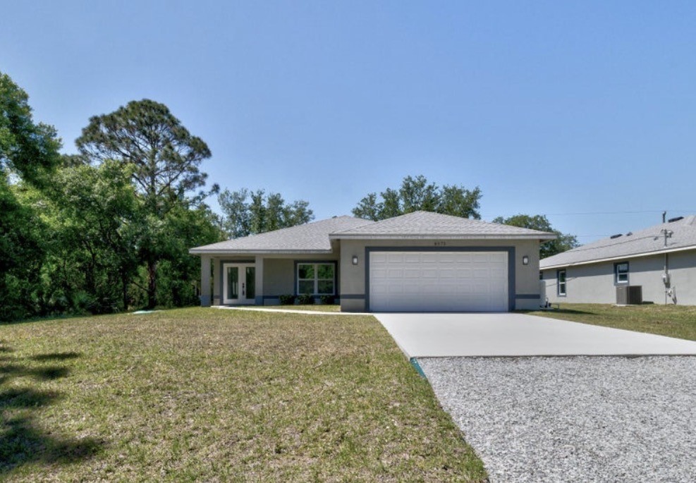 Contemporary single-story residence with a gray exterior and white trim