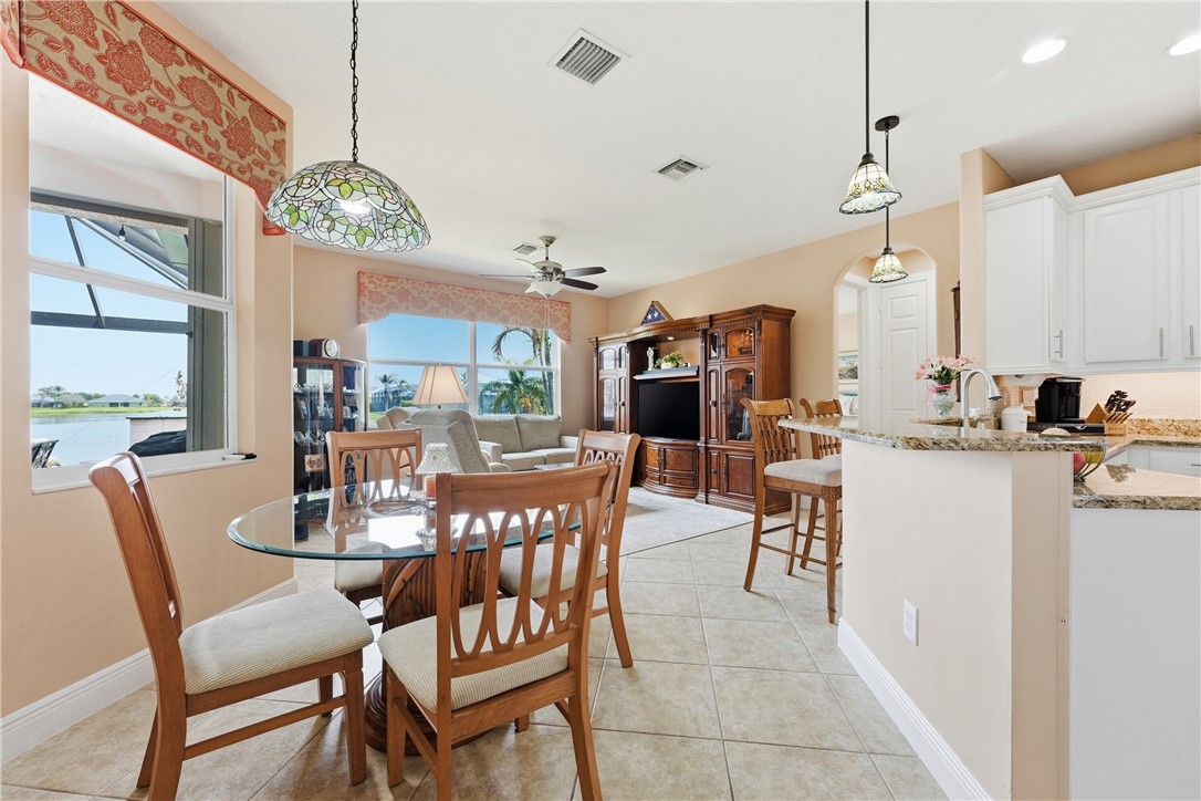 Open-concept living area with tile flooring and abundant natural light