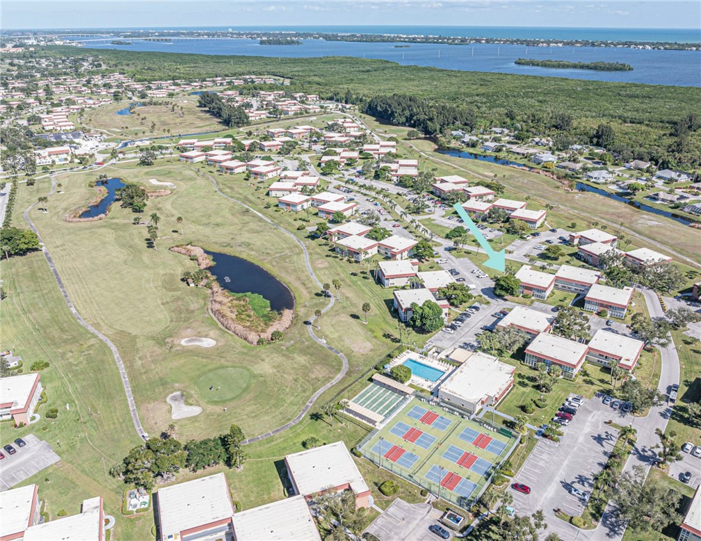 View of property location with a large body of water, nearby suburban area, and a golf club