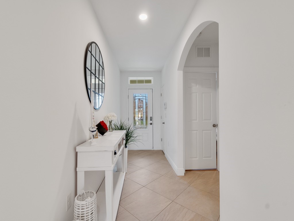 Entryway featuring neutral-toned tile flooring laid in a diamond pattern