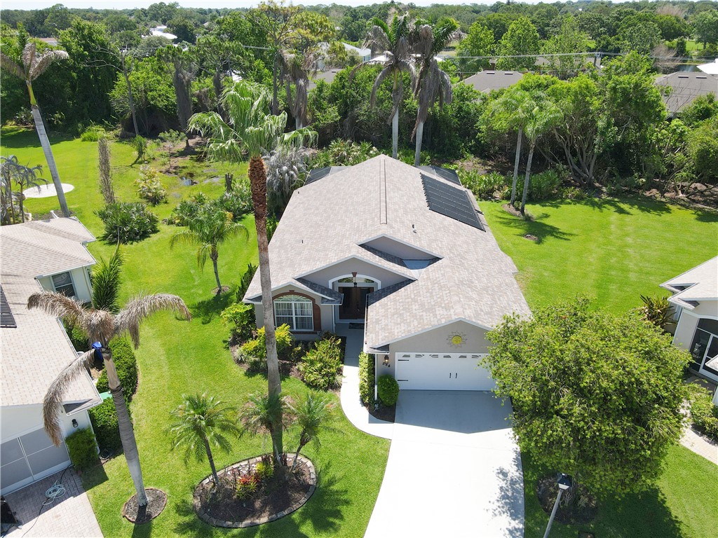Contemporary single-story residence featuring a light gray exterior, a two-car garage, and a concrete driveway