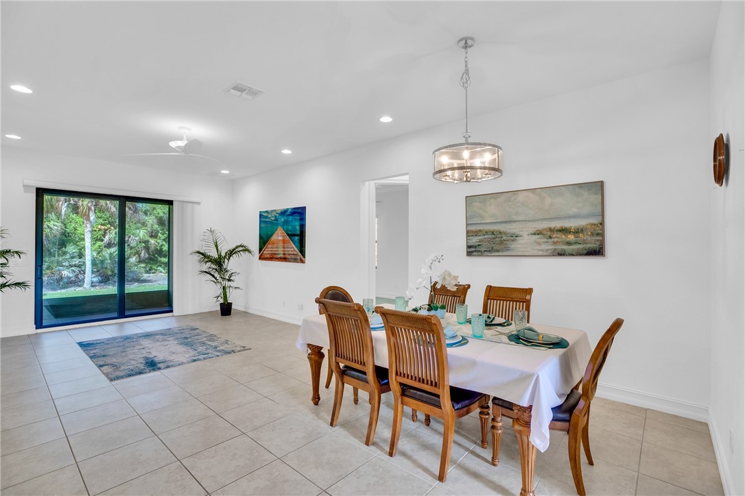 Dining space featuring light tile patterned flooring, ceiling fan, and recessed lighting