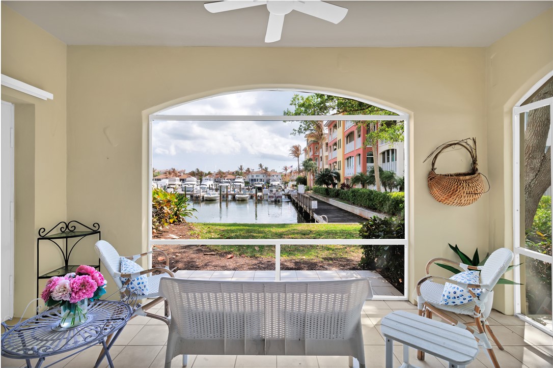 Sunroom with a beautiful water view and a ceiling fan