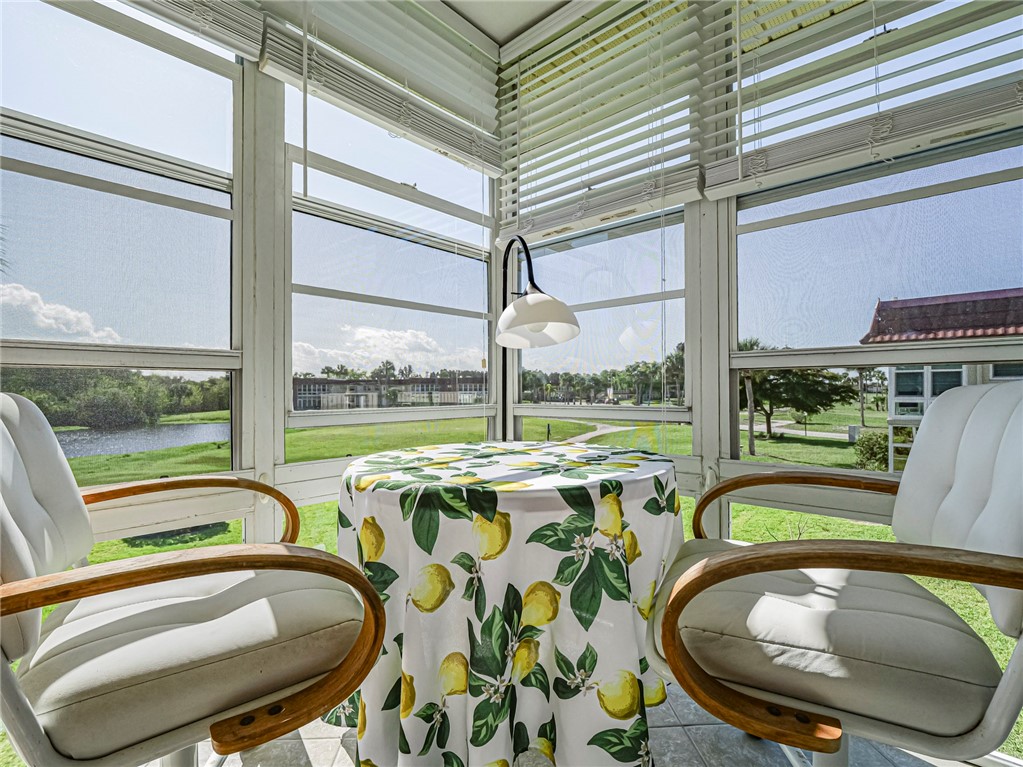 Sunroom featuring plenty of natural light and a water view