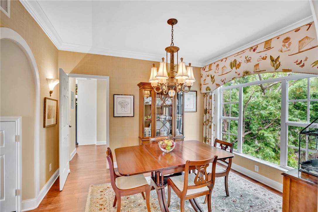Formal dining area with shaded oak views