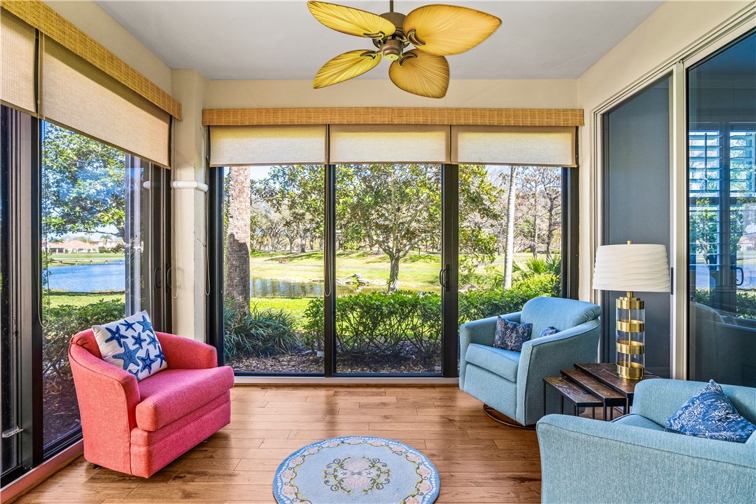 Sunroom featuring hardwood / wood-style flooring, a water view, and plenty of natural light