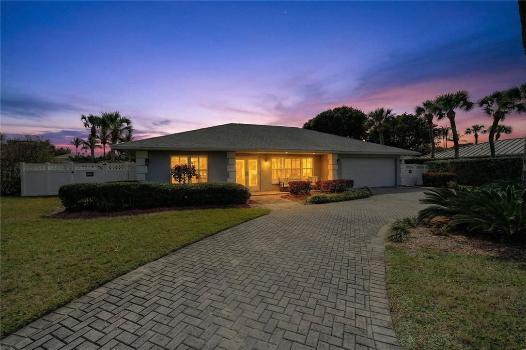 Ranch-style home with decorative driveway and a garage