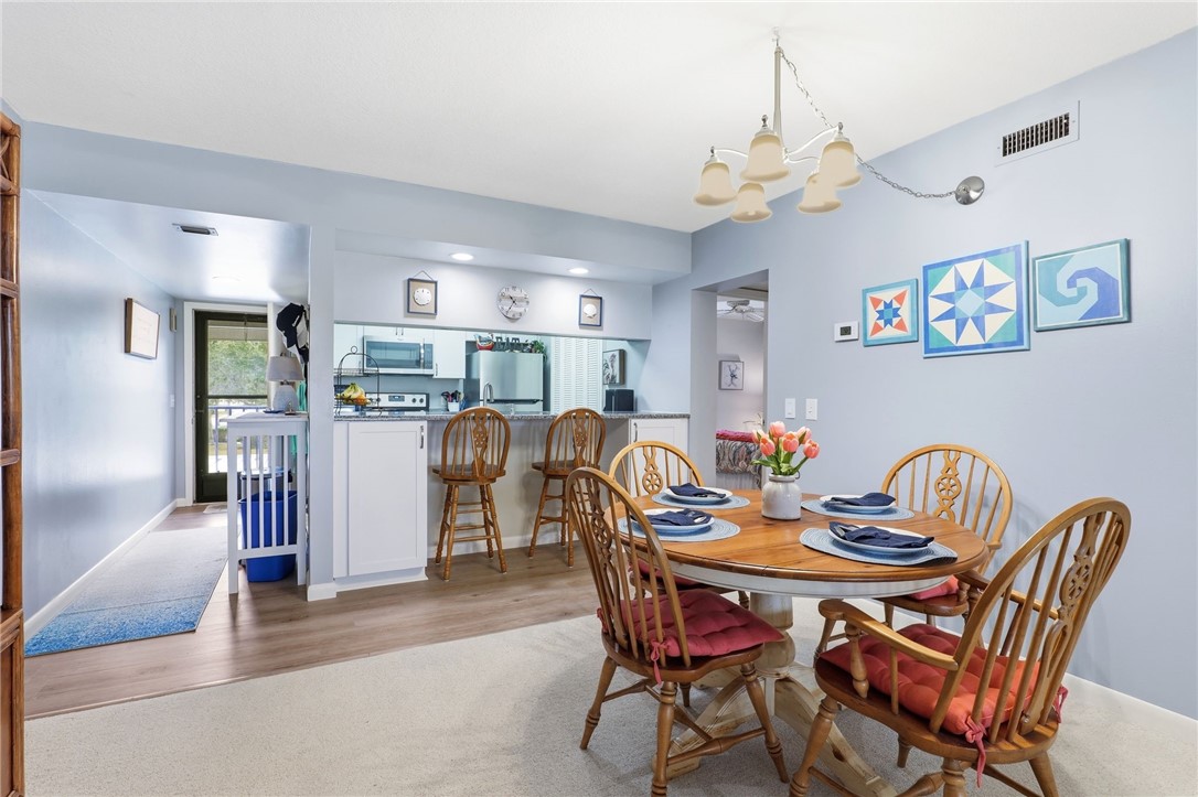 Dining space with a chandelier and light wood-style flooring