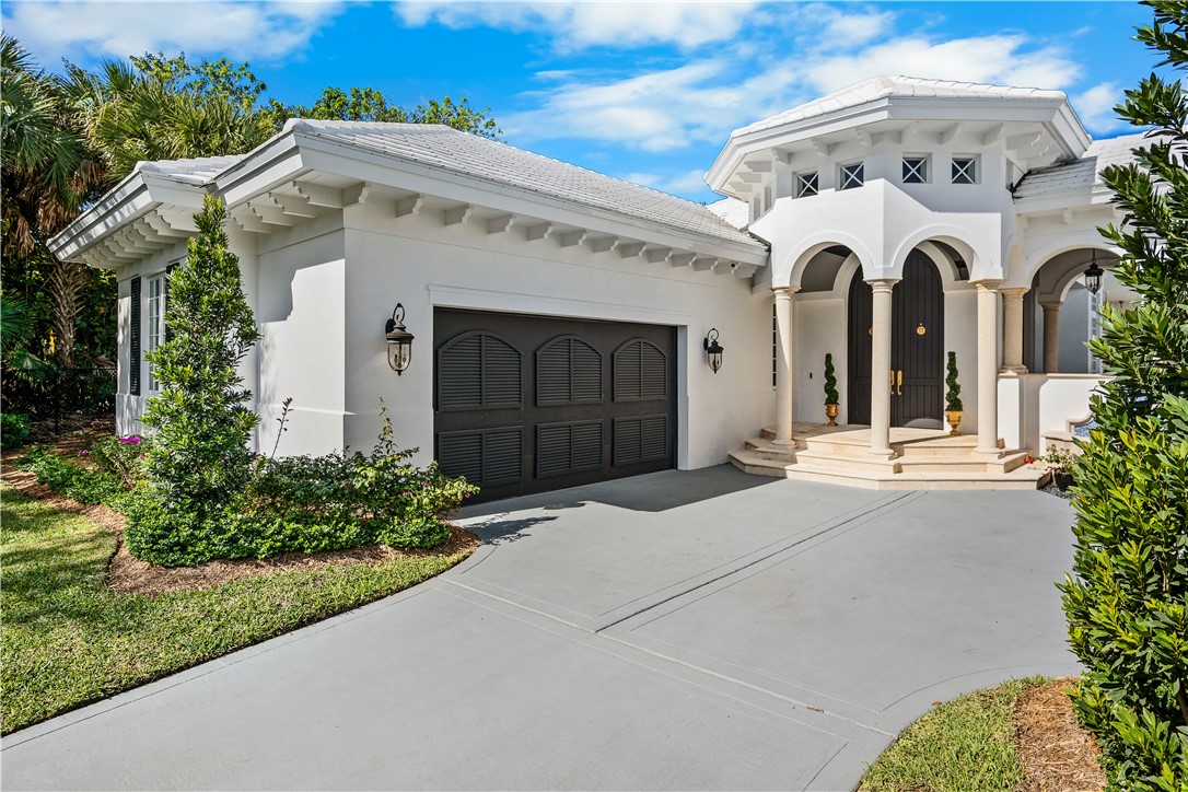 Mediterranean / spanish home featuring concrete driveway, stucco siding, and an attached garage