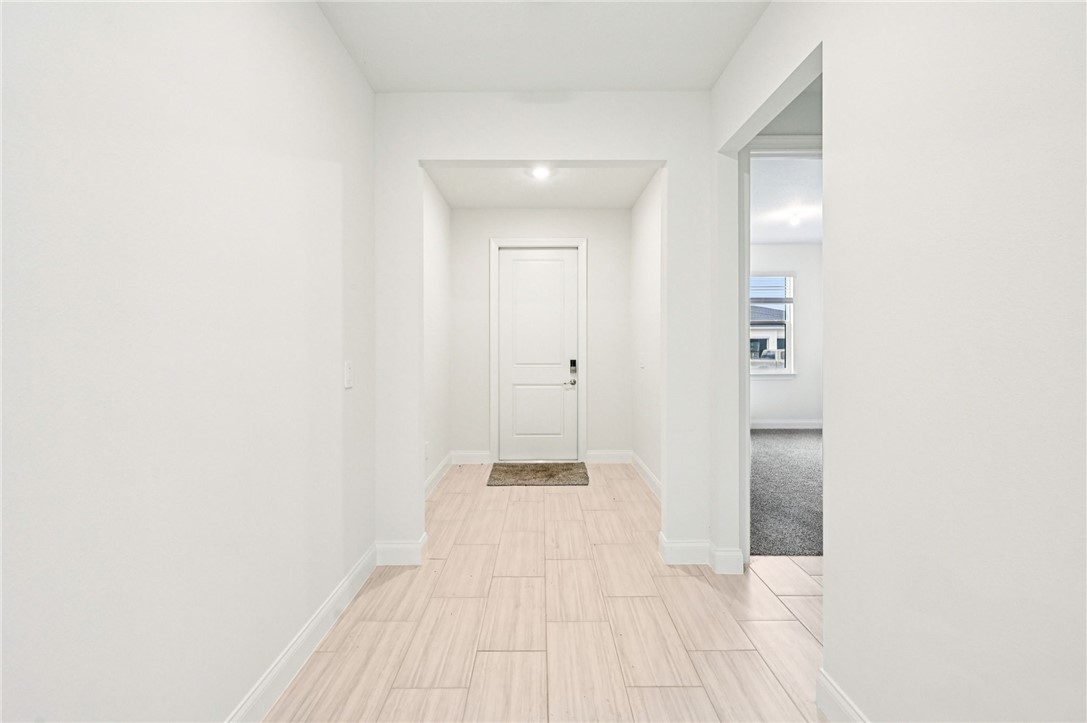 Corridor featuring baseboards