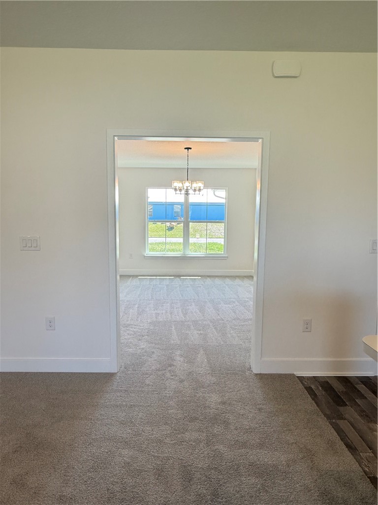 Dining room featuring a chandelier and carpet