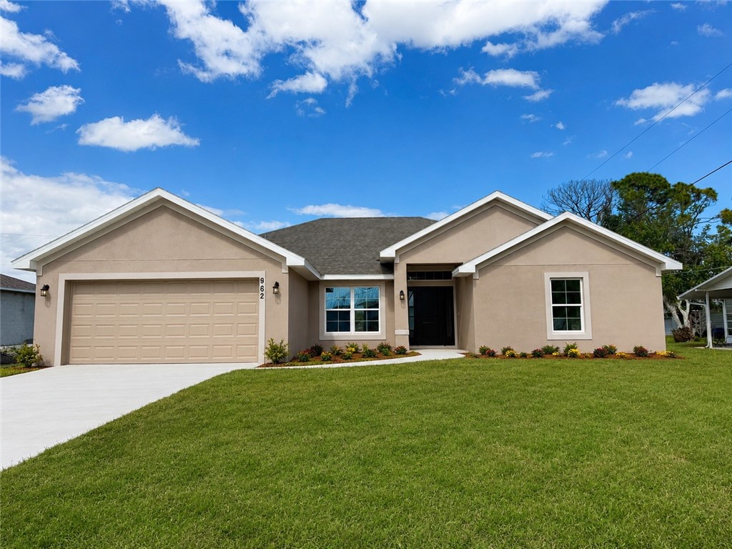 Single story home featuring a front lawn, concrete driveway, stucco siding, and a garage.
Front exterior images have been enhanced using AI technology to illustrate potential landscaping. Actual property appearance may vary.