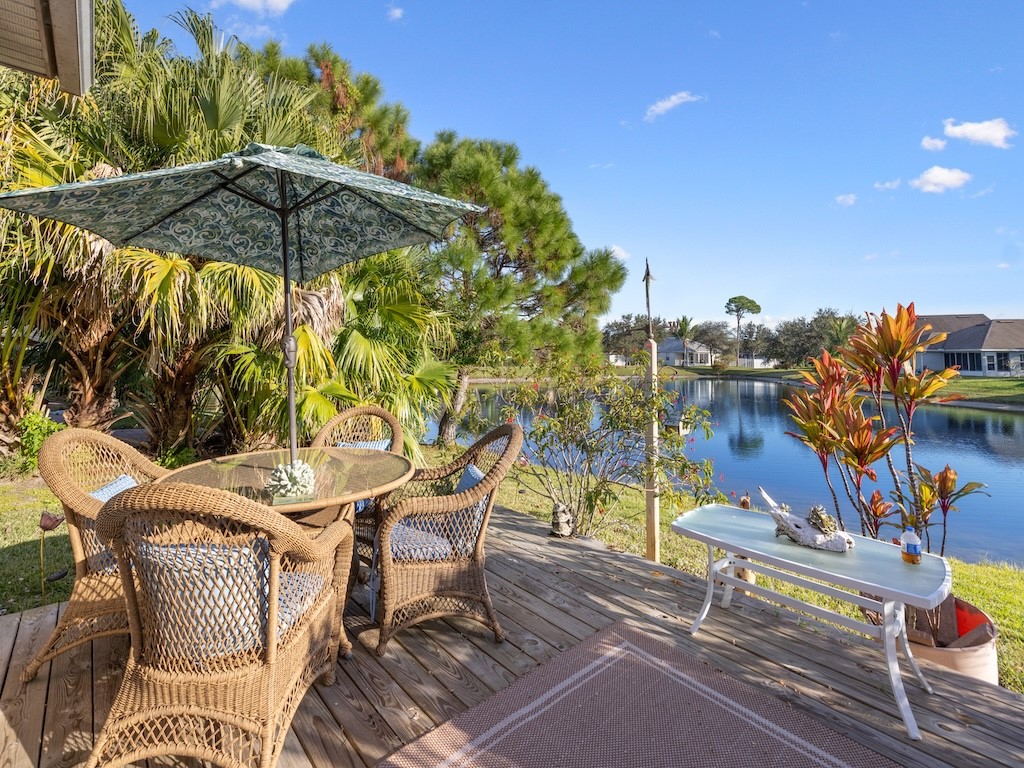 Wooden deck featuring outdoor dining space and a water view