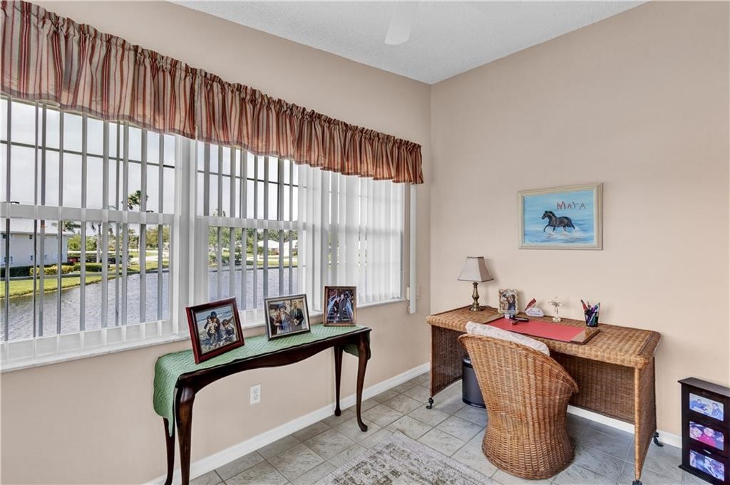 Office featuring tile patterned flooring and baseboards