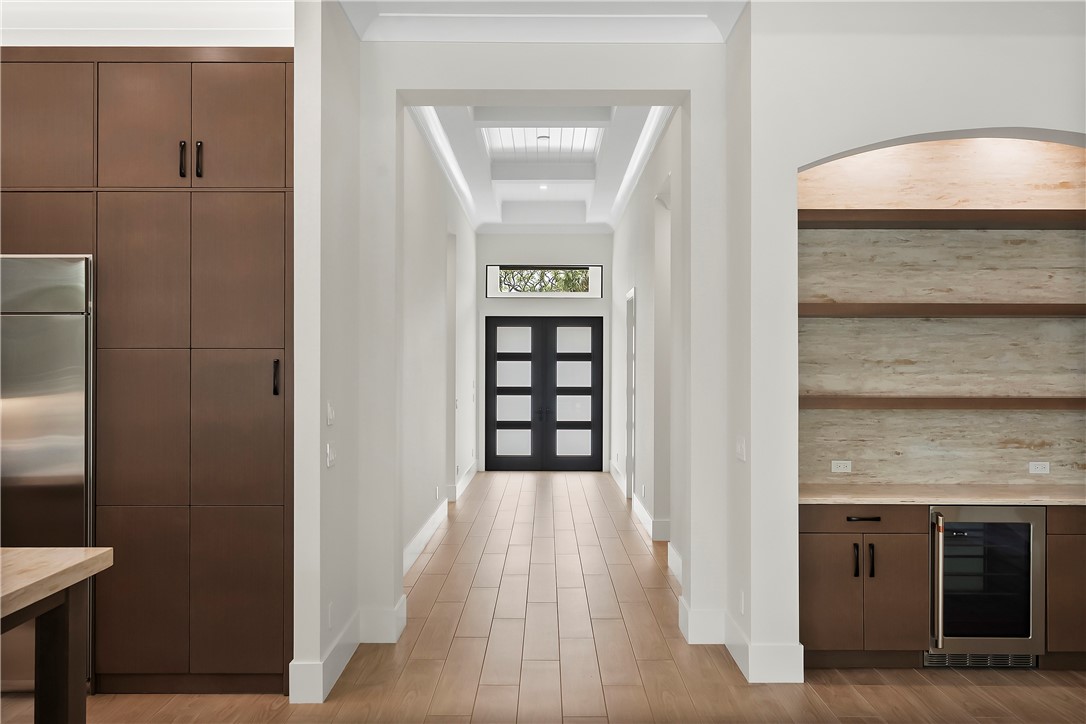 Foyer featuring beverage cooler and light wood-type flooring