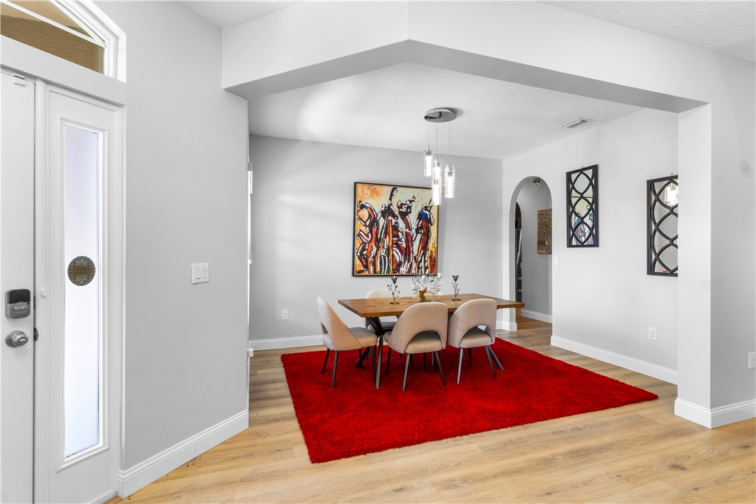 Recessed lighting, wood-finish flooring, and arched doorways