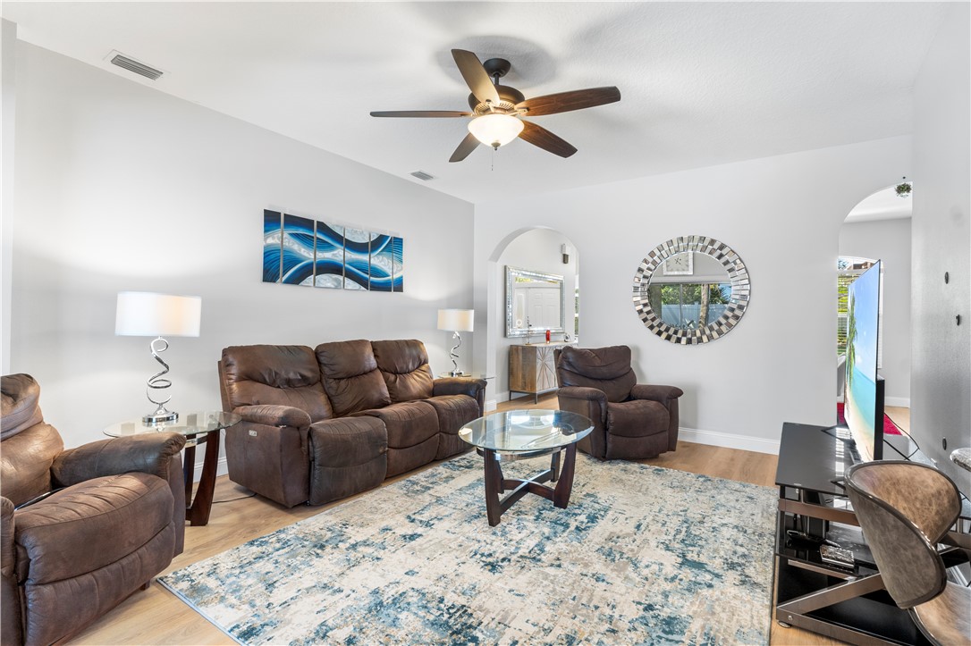 Light-toned wood-finish flooring complements the neutral wall color