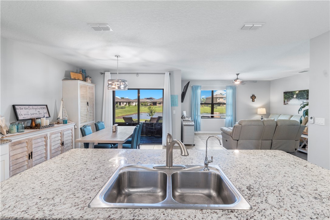 Spacious kitchen island with dual basin stainless steel sink and granite-finish countertop