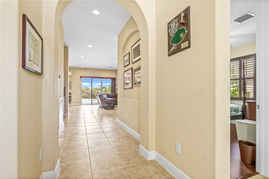 Hallway featuring arched walkways, and recessed lighting