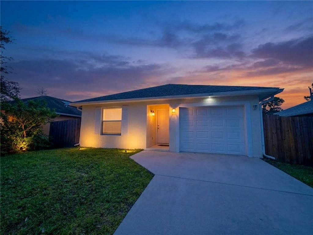 Single-story residence featuring a two-car garage, concrete driveway, and stucco exterior
