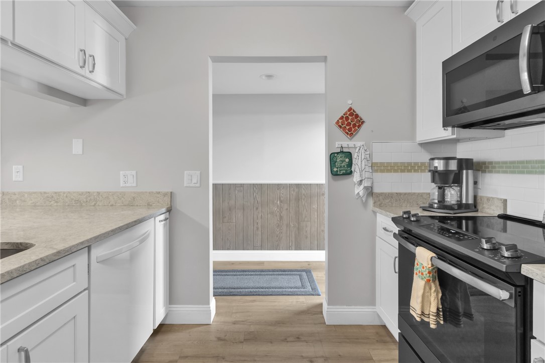 Tile backsplash, slide in range, pantry gorgeous counters + so much more in this beautiful upgraded kitchen!