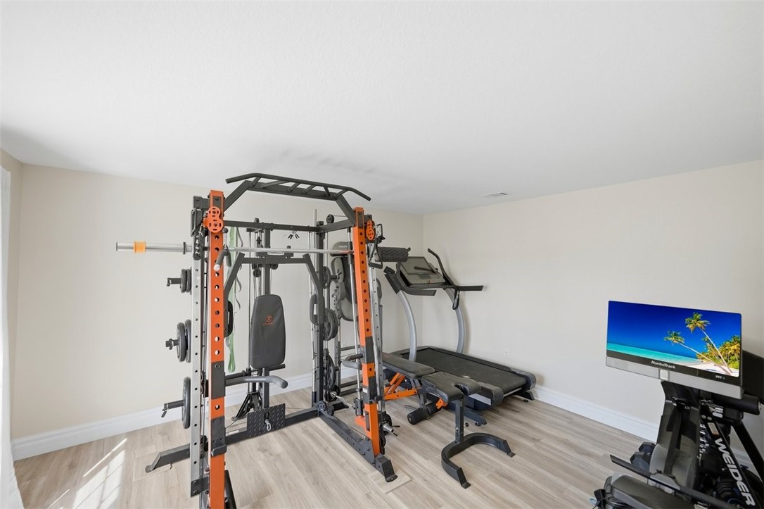 Light wood-finish flooring with white baseboards and neutral wall tones