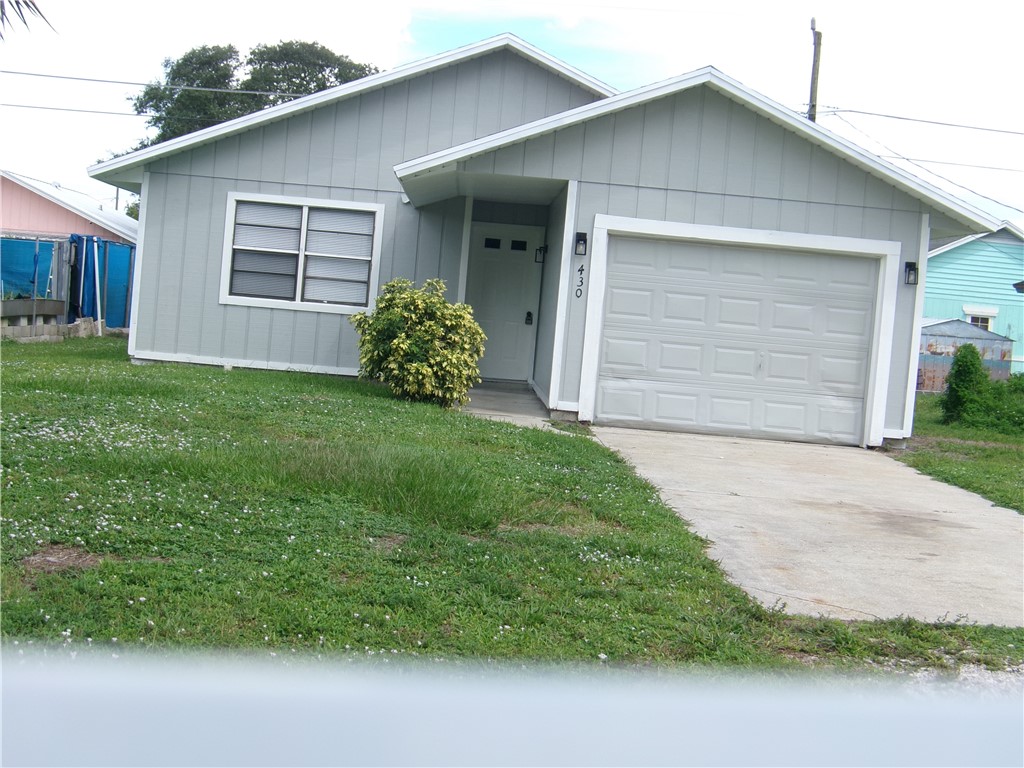 Exterior featuring vertical siding and a single-car garage