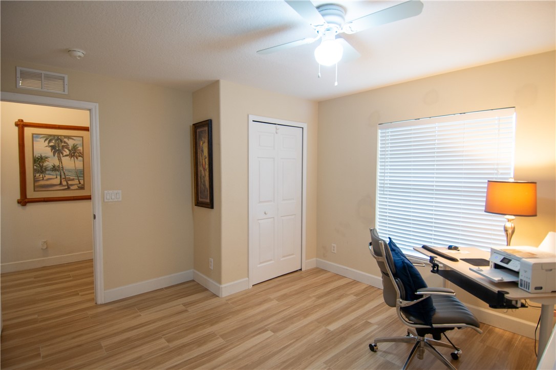 Light wood-finish flooring, recessed lighting, and a ceiling fan with light fixture