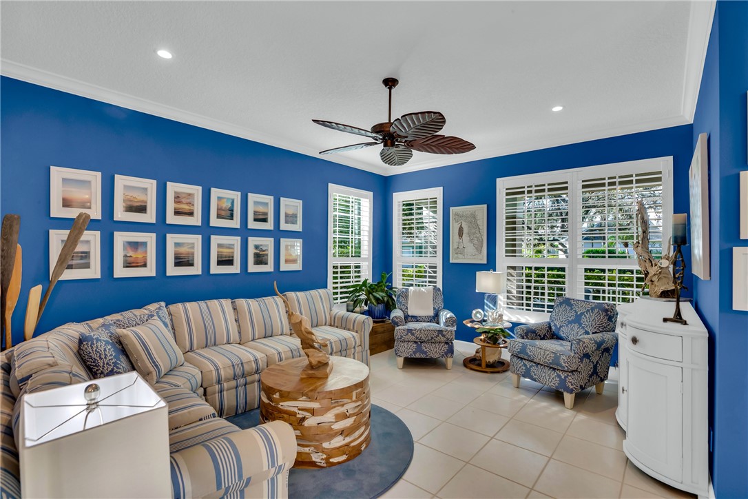 Recessed lighting, crown molding, ceiling fan, tile flooring, and plantation shutters