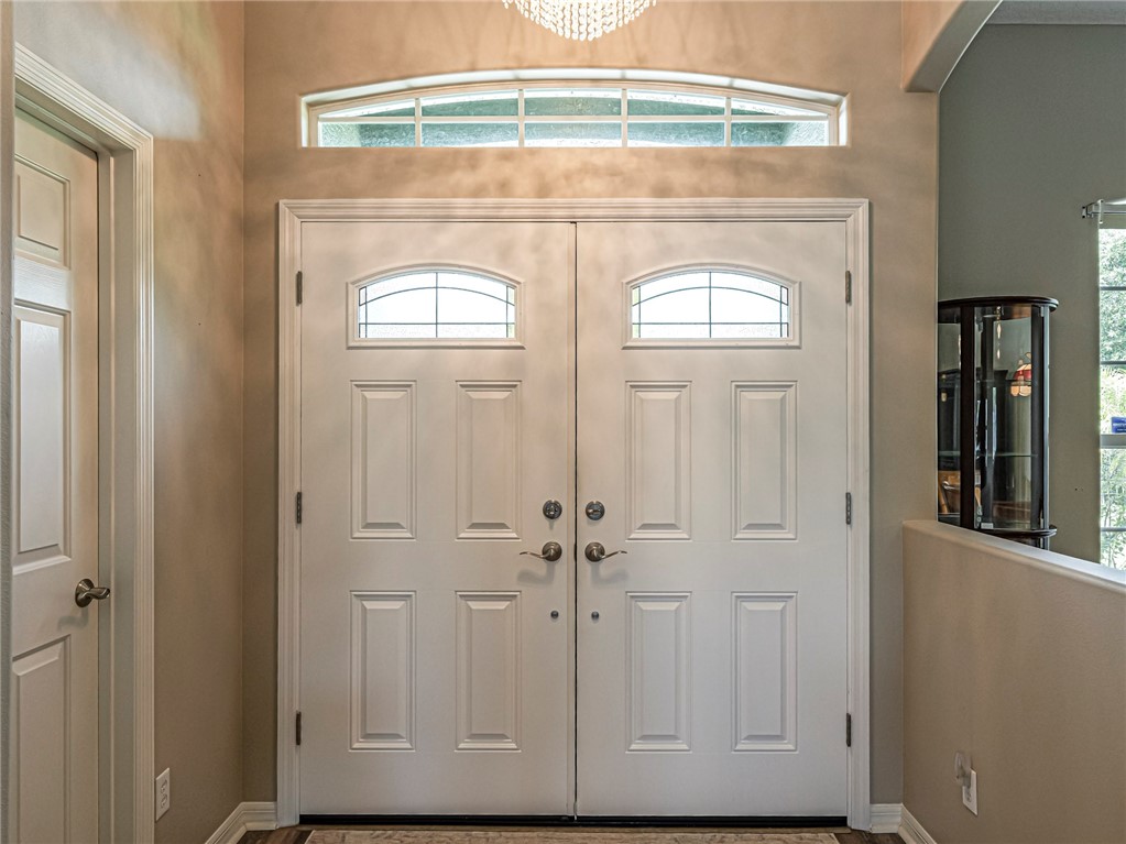 Double entry doors with arched transom windows and an arched transom above