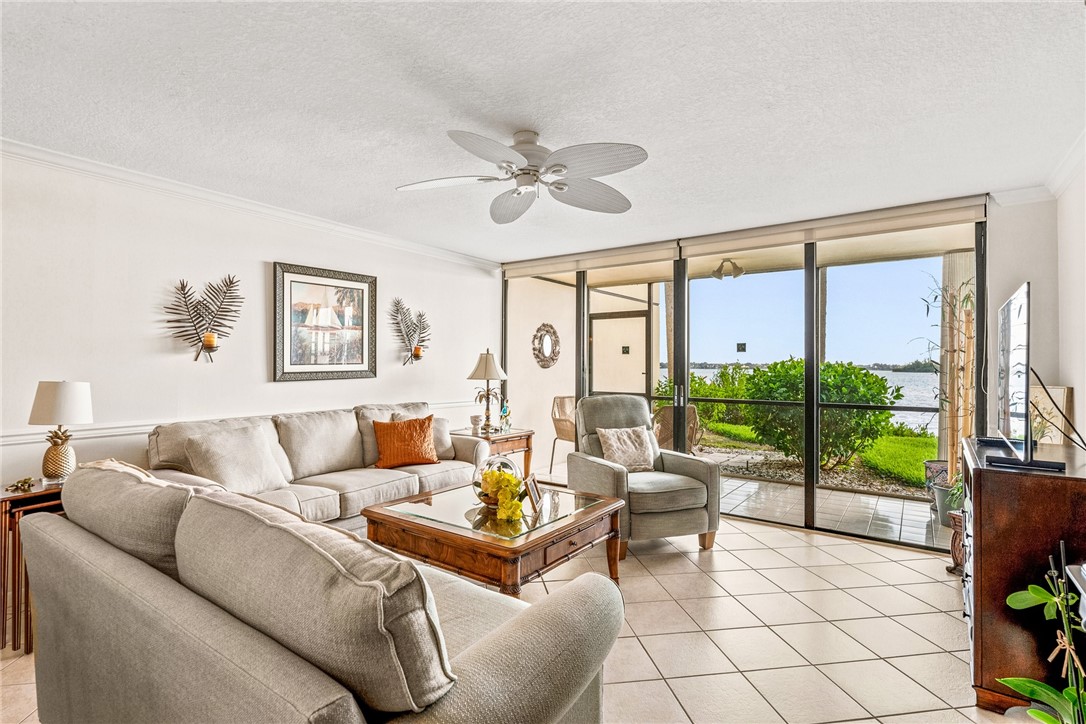 Spacious living room looking through screened porch to the beautiful intracoastal waterway