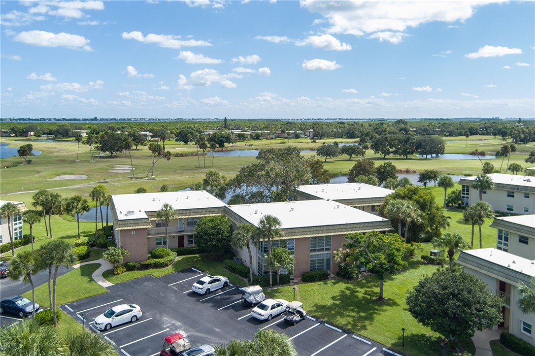 Aerial perspective showcasing residential buildings with surrounding natural elements building on back right corner nestled in with corner views galore!